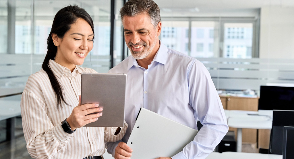 Casual business team man and woman looking at tablet mobile