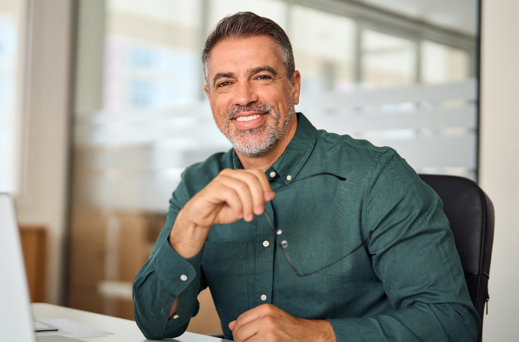 Middle aged professional man at desk tablet